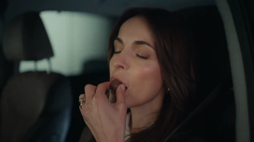 A woman eating an EGO praline.